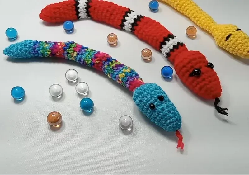 Crochet amigurumi snake fidget with marble rattle