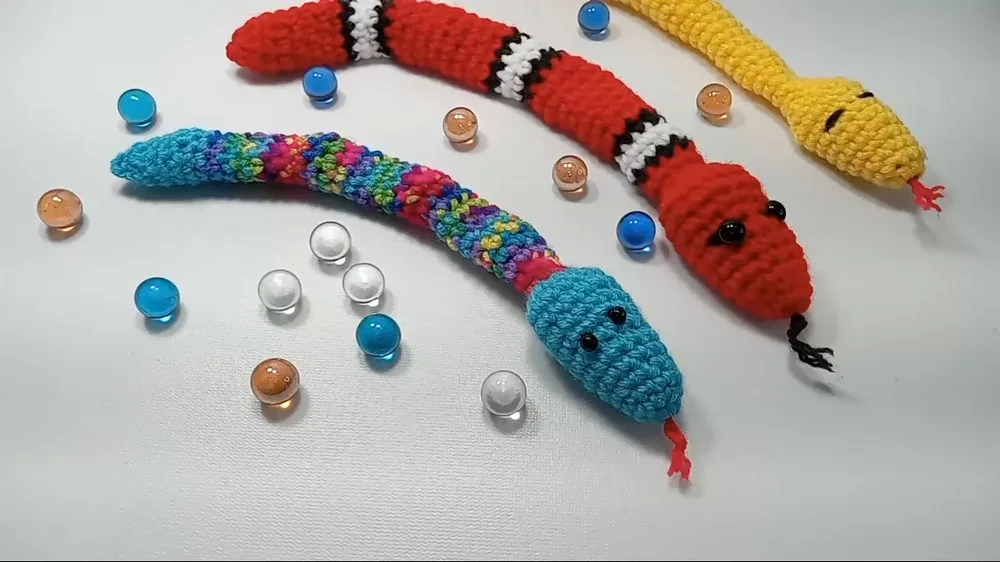Crochet amigurumi snake fidget with marble rattle