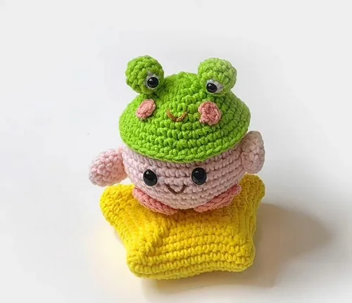 Crochet frog hat pattern with 3D eyes and blush cheeks